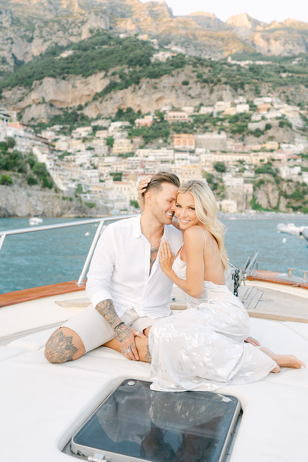happy couple on a boat for their proposal photo session