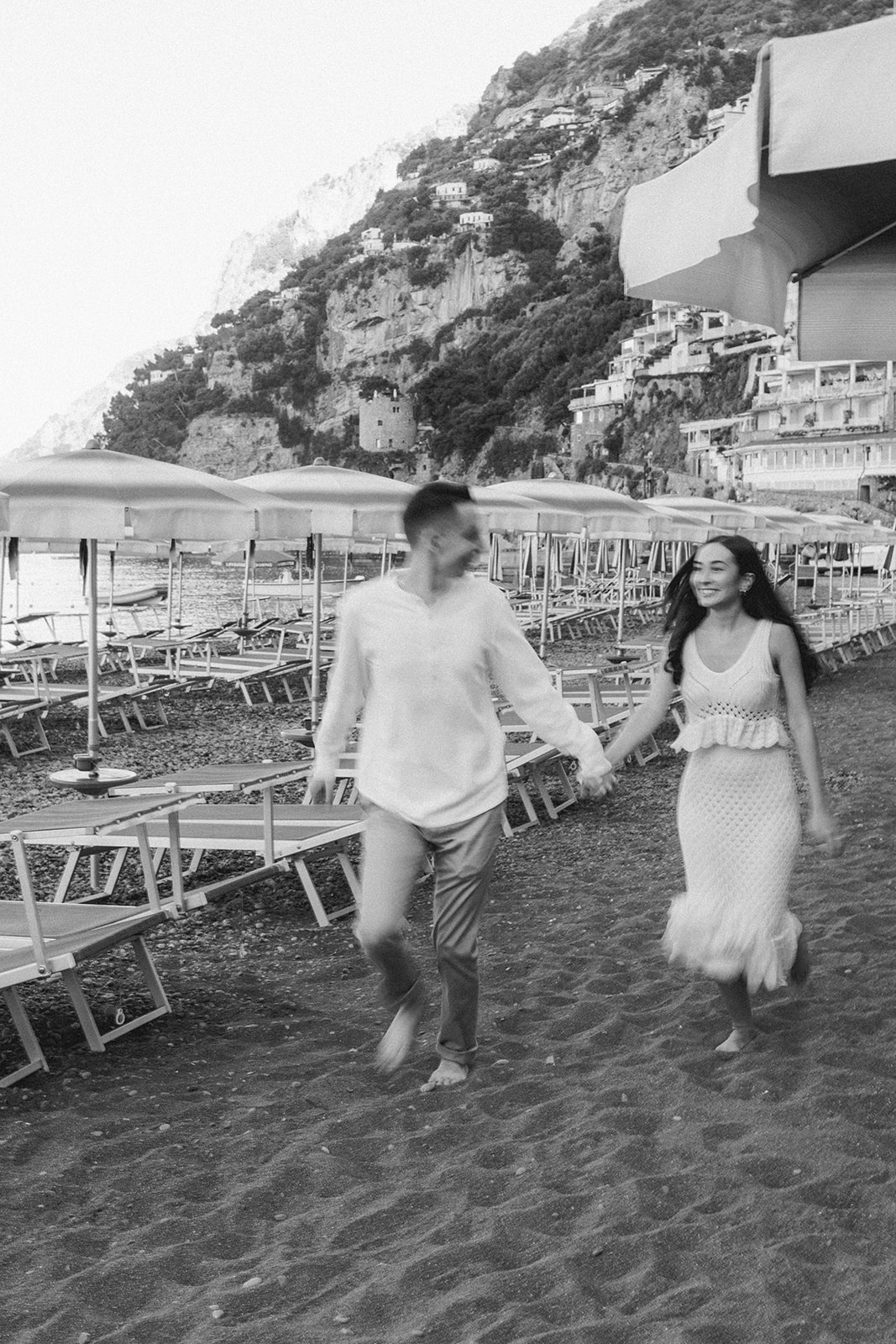 couple running and having fun in engagement photoshoot