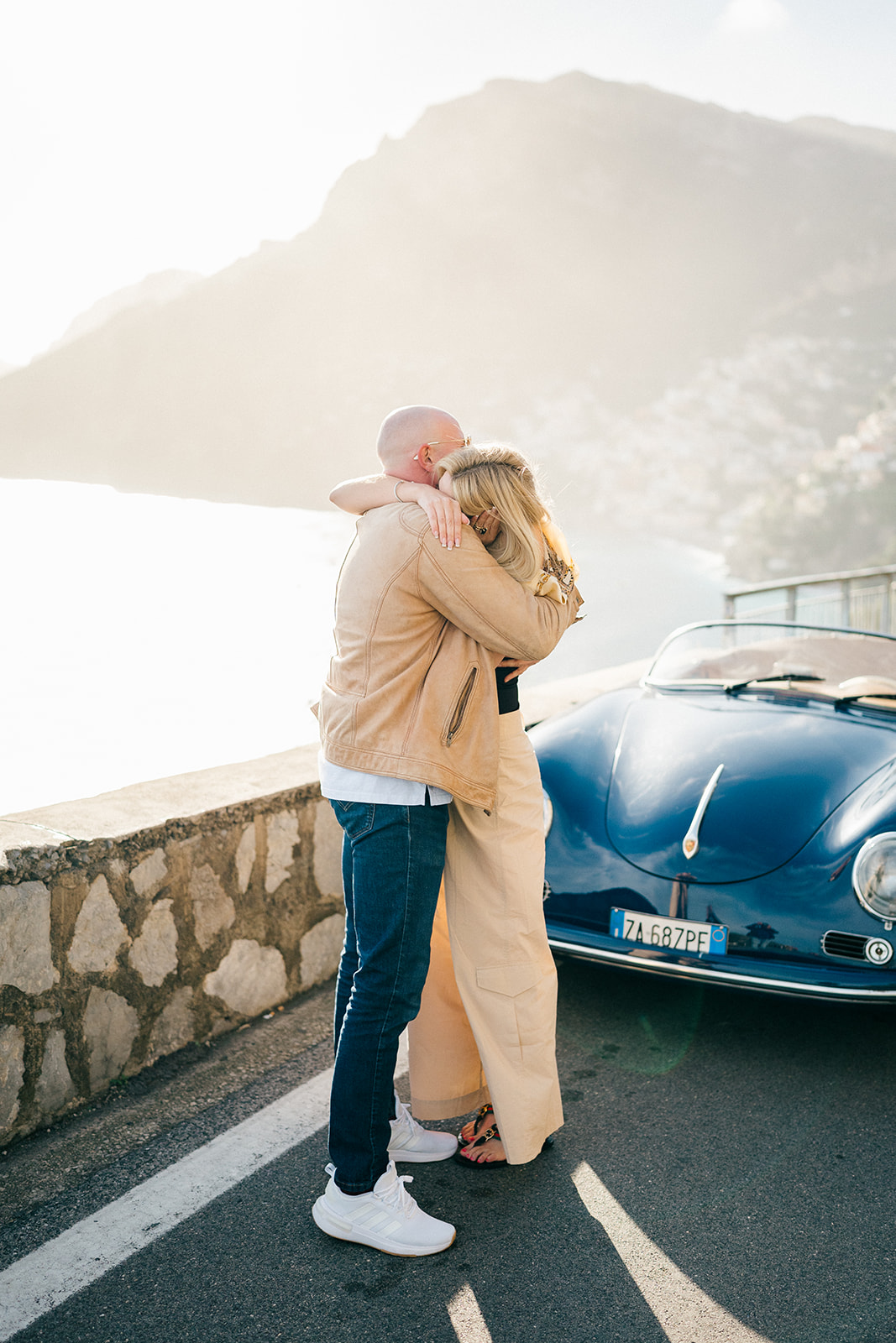 happy couple hugging after surprise marriage proposal 