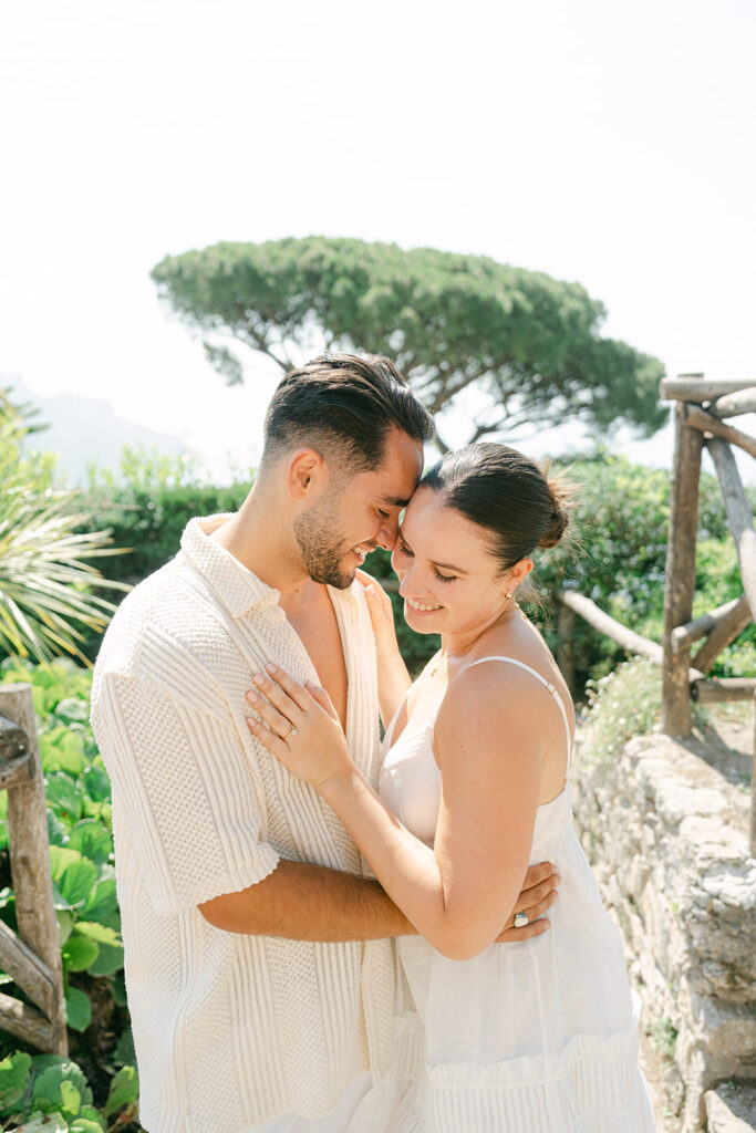 Happy couple hugging in a garden of ravello