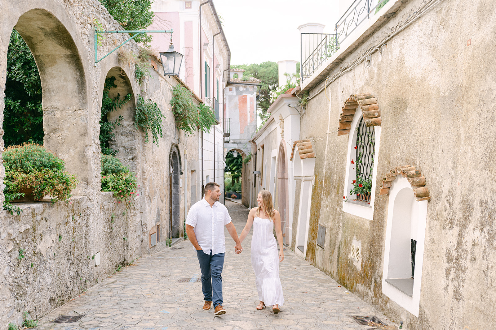 couple holding hands walking in Ravello, Italy