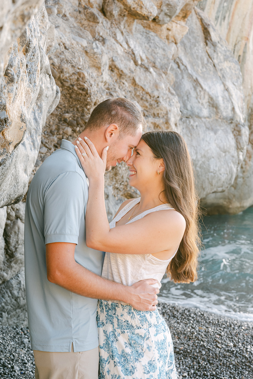 couple hugging at the beach for a summer engagement shoot