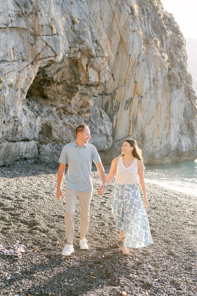 couple holdings hands at the Amalfi Coast beach