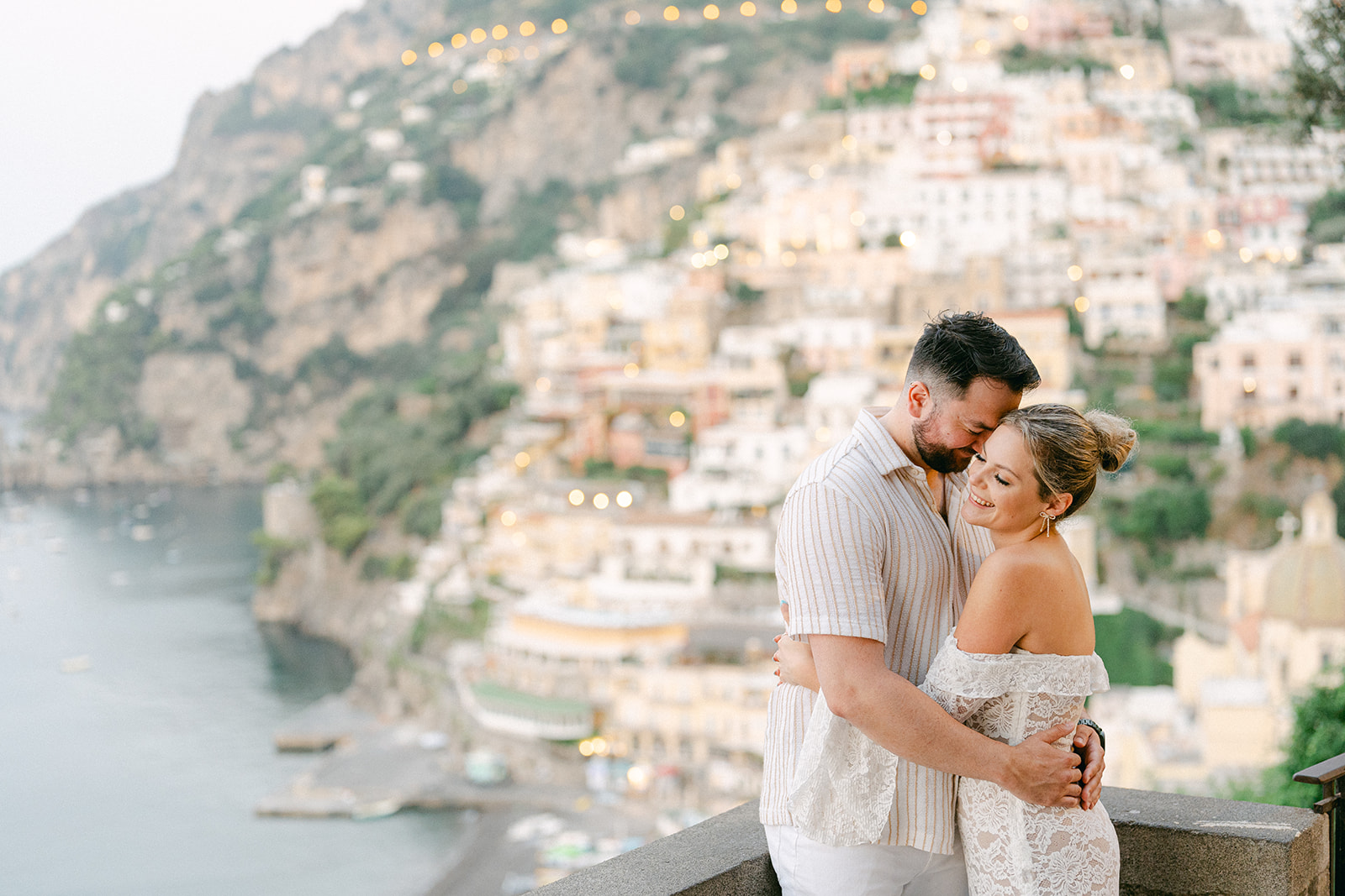 a classic Positano view with a happy couple hugging