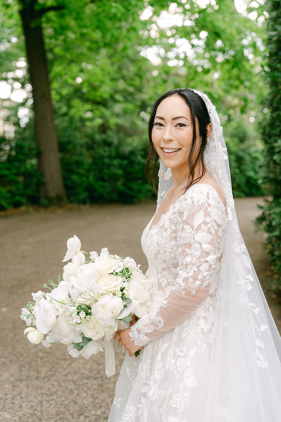 bridal photo wearing lace wedding dress in the Garden
