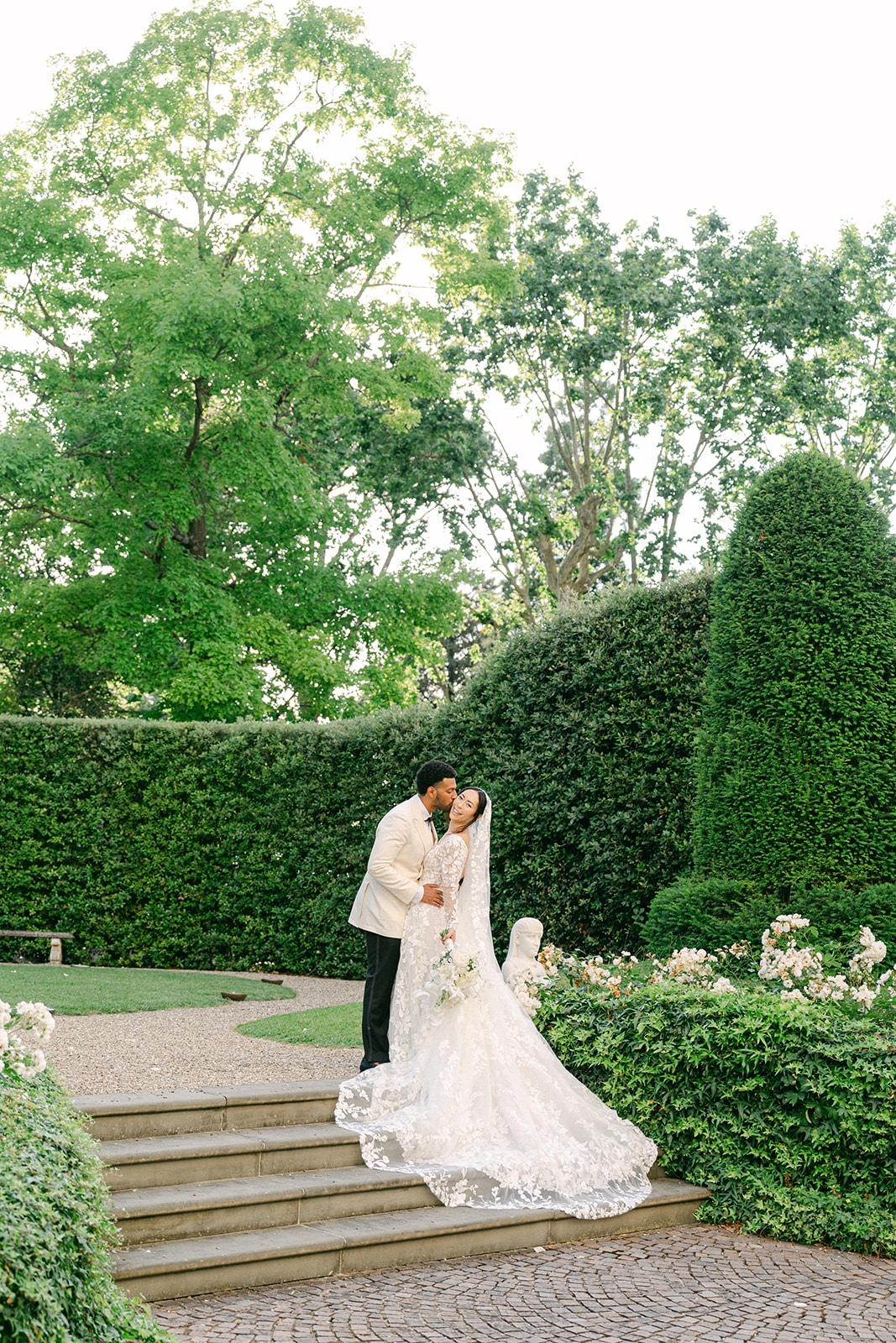 groom kissing the bride not he cheek for a outdoor wedding portraits