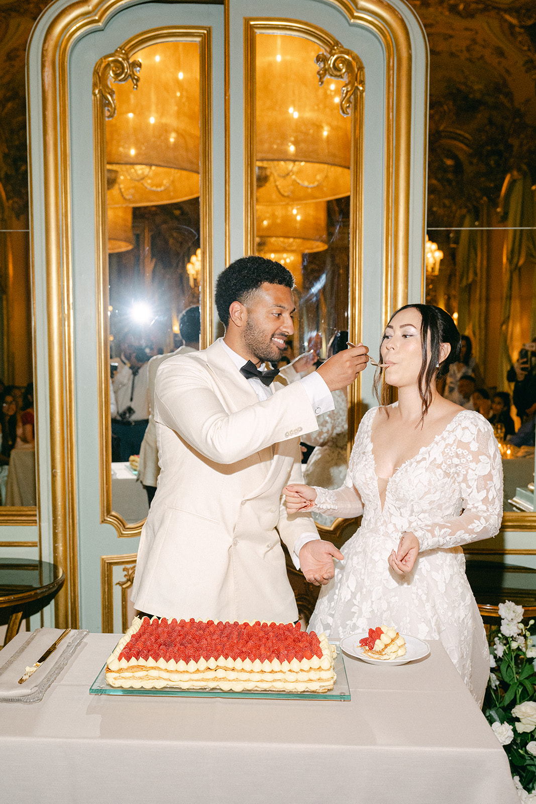 groom feeding the bride a bite of the wedding cake during wedding reception