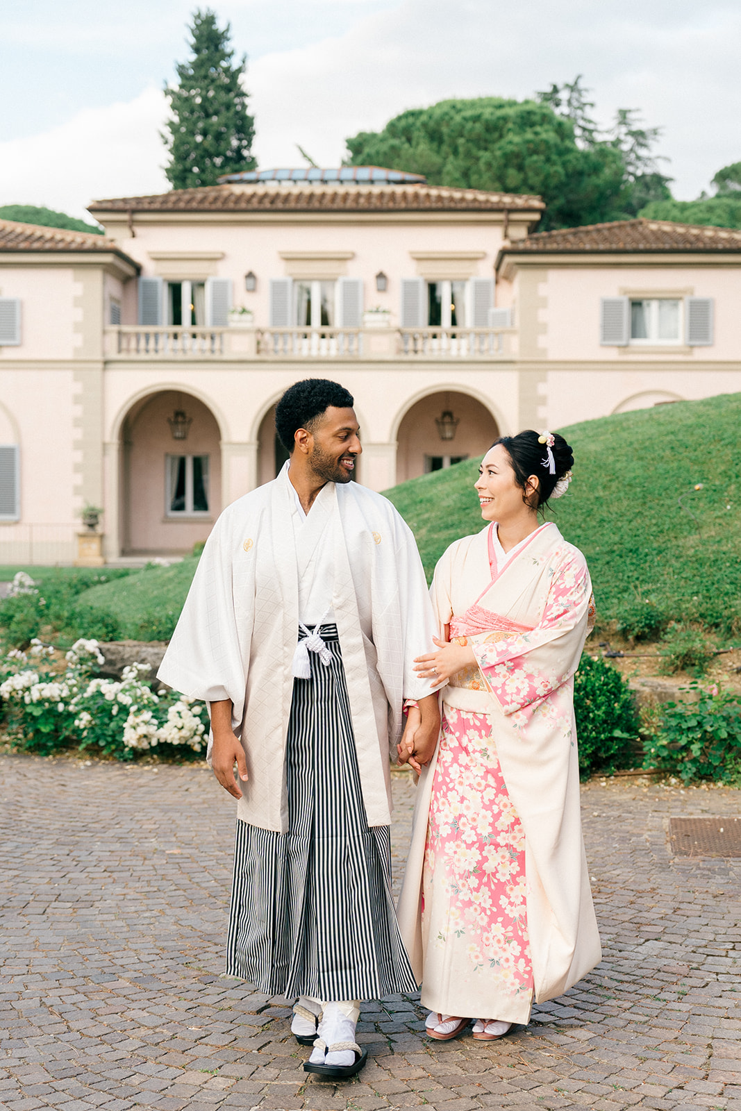 candid wedding photo of the bride and groom outdoors in Villa Cora wearing traditional wedding attire
