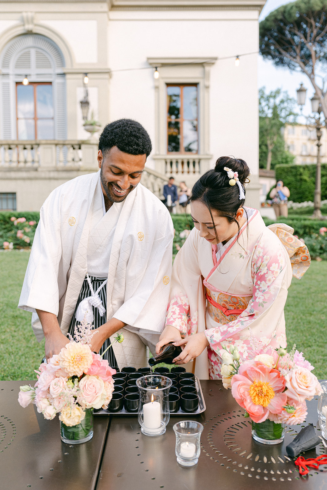 bride and groom pouring sake of the guests during wedding ceremony