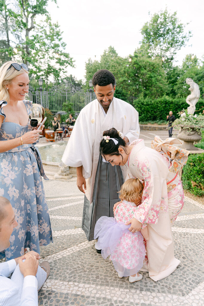 documentary wedding photo of a little girl hugging the bride wearing her Japanese traditional attire
