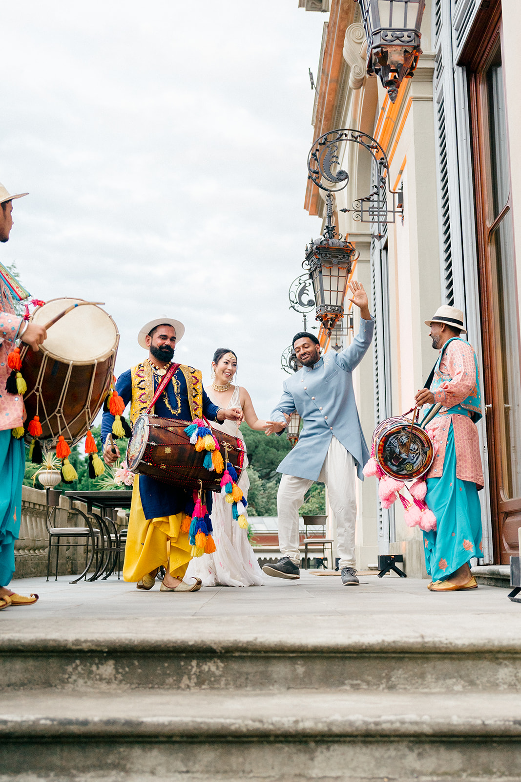 bride and groom dancing with tradition Indian drummers during pre-wedding in Italy