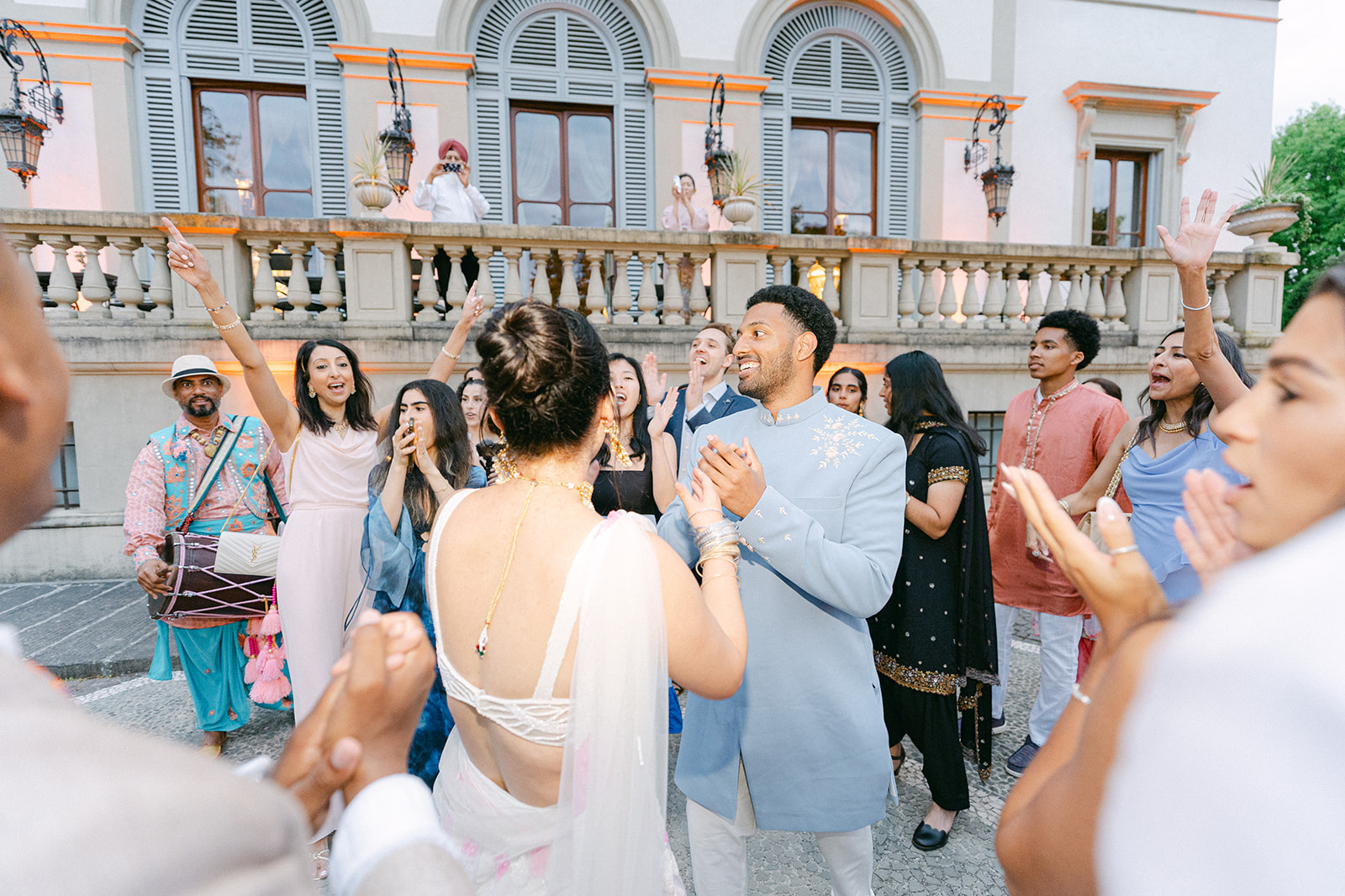 Bride and groom dancing with the guests during wedding party with Indian music and Indian wedding Attire
