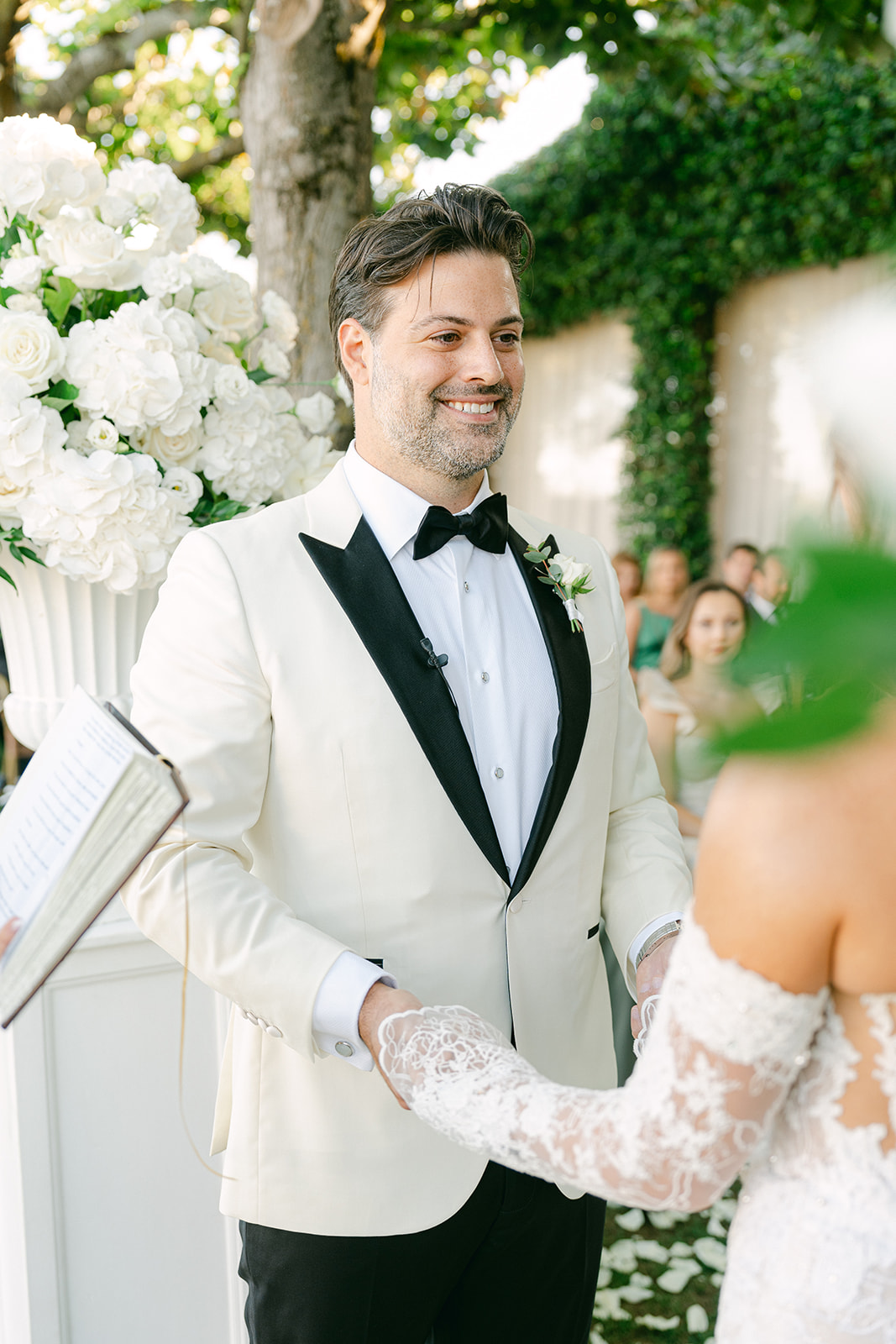 groom smiling during wedding ceremony