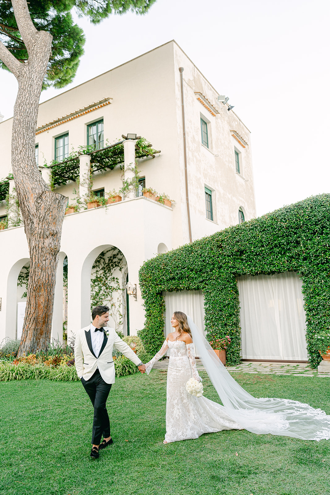 Bride and groom walking off in their wedding venue, Villa Eva