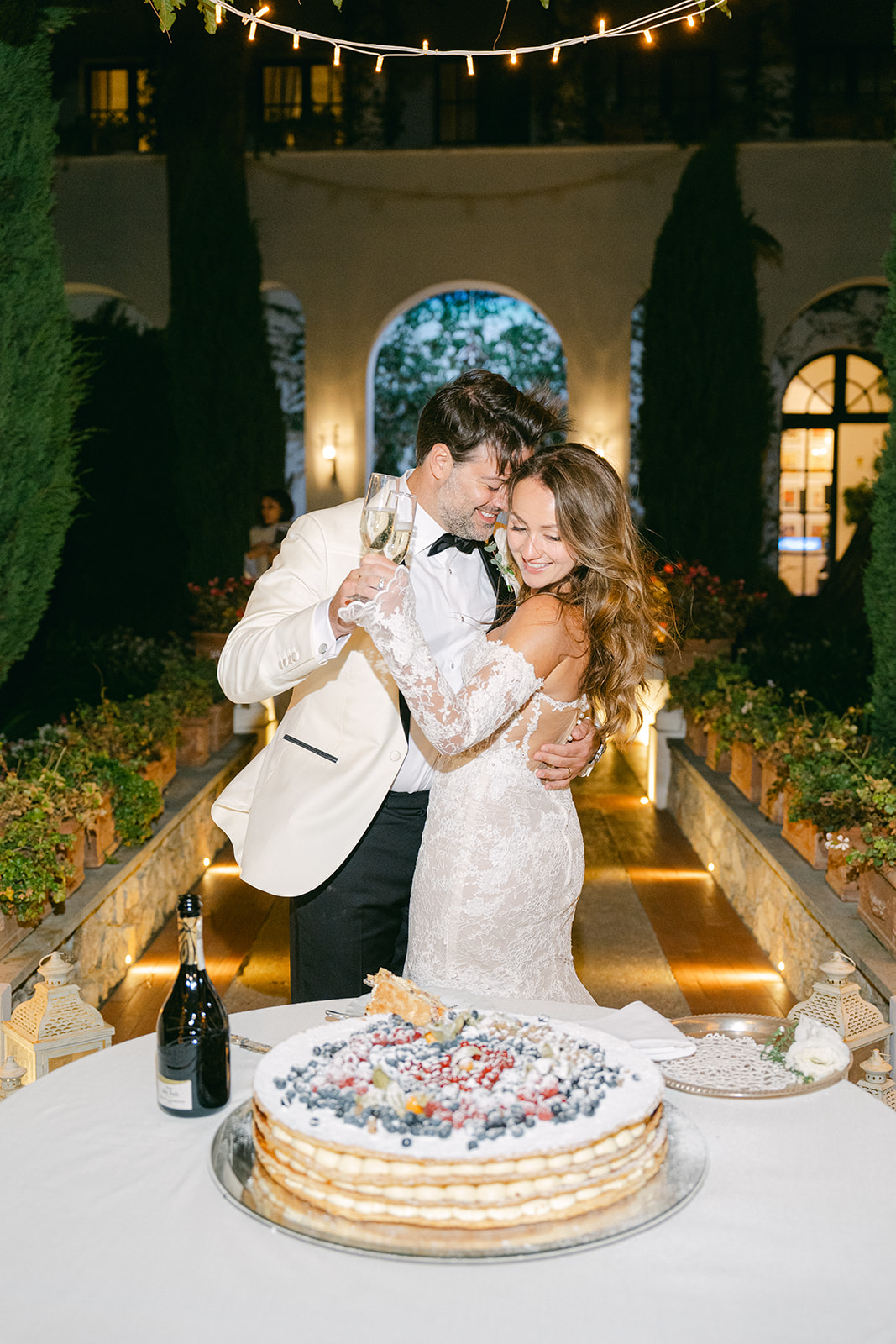 flash photography of the wedding couple during cake cutting