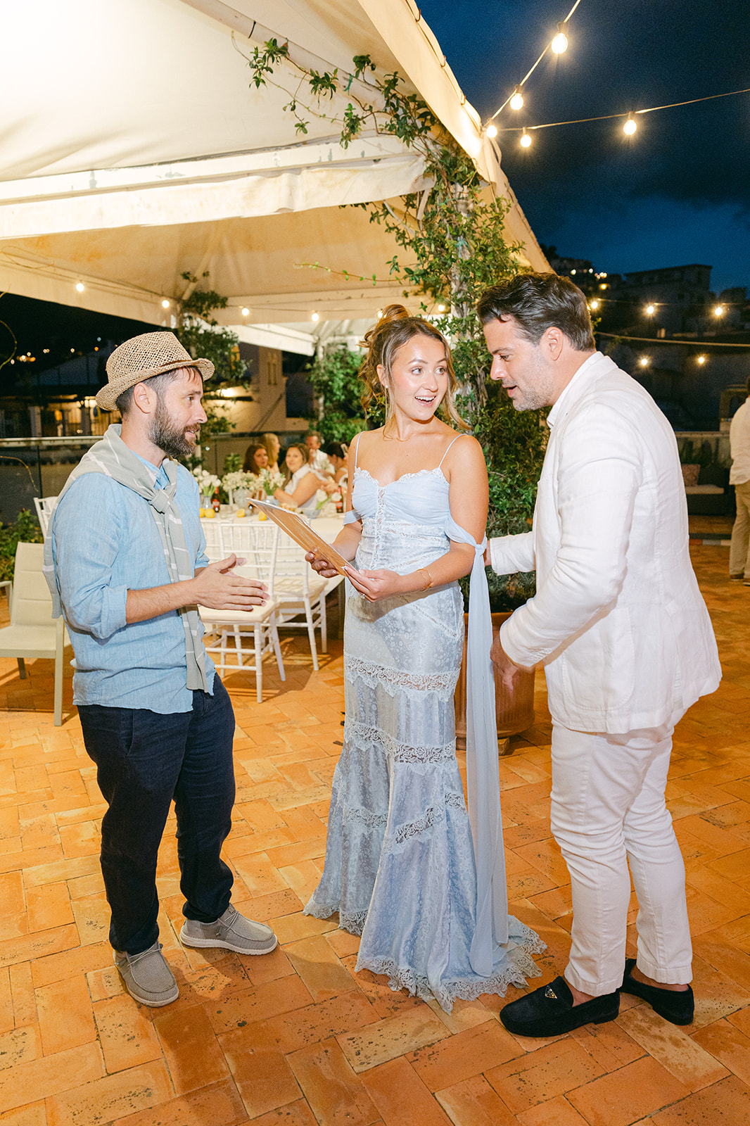 candid photo of the couple with the live local watercolor painter from Amalfi Coast Paintings