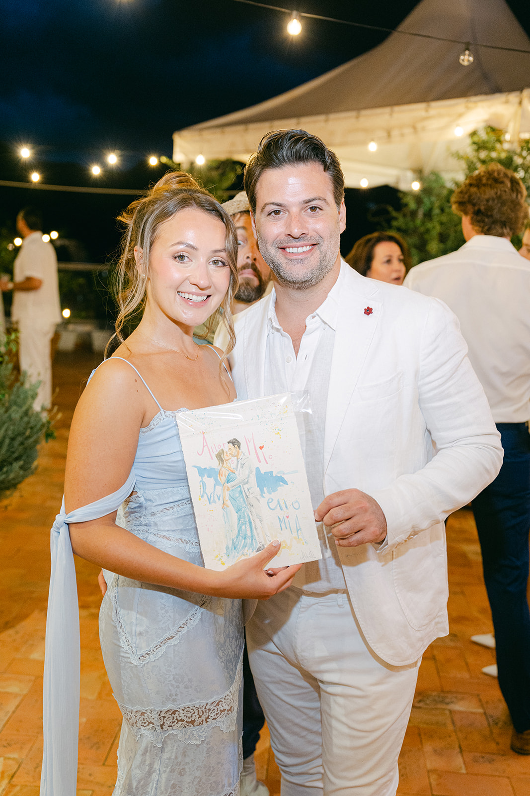 the wedding couple with their watercolor painting!