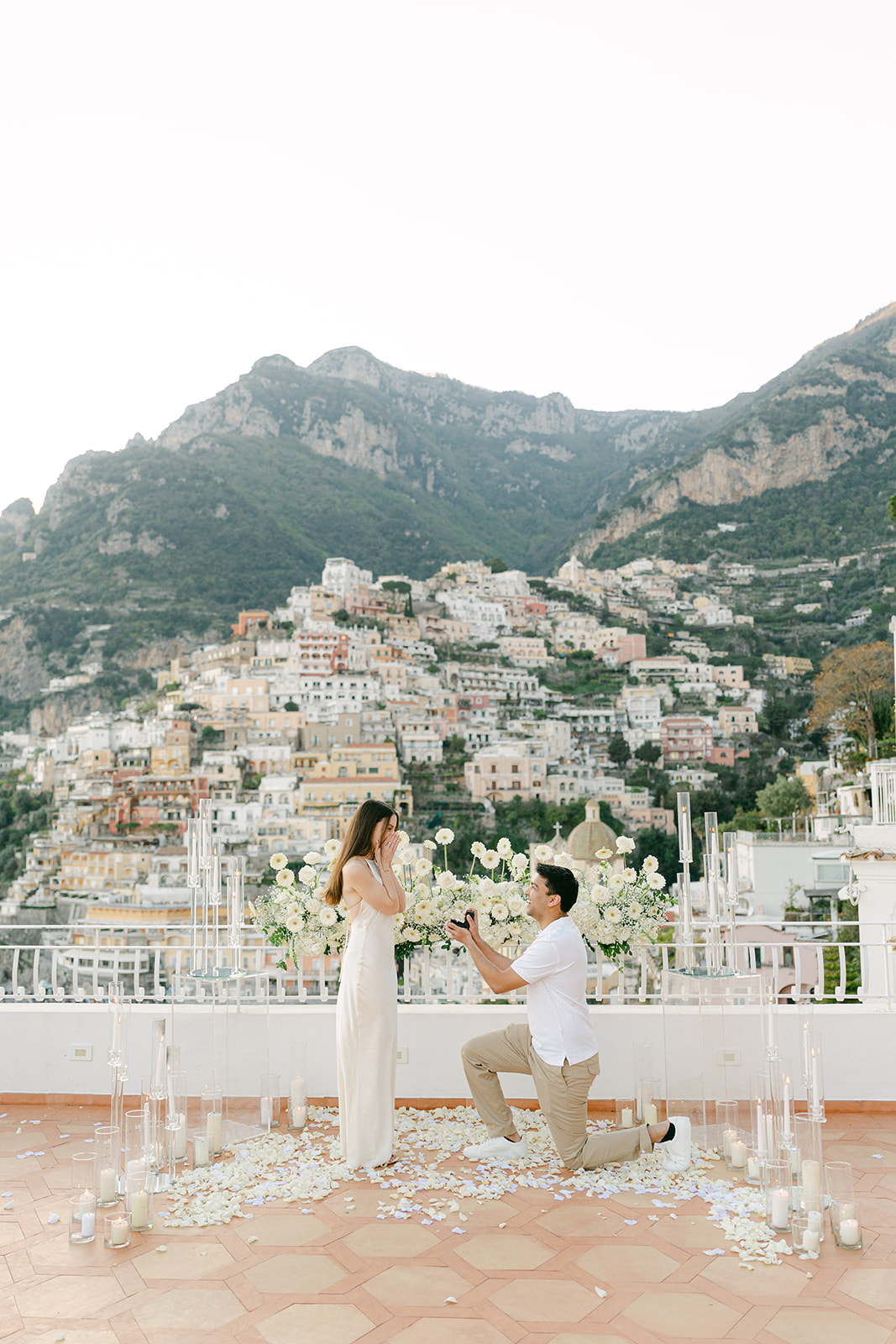 man kneeing down and proposing to his girlfriend