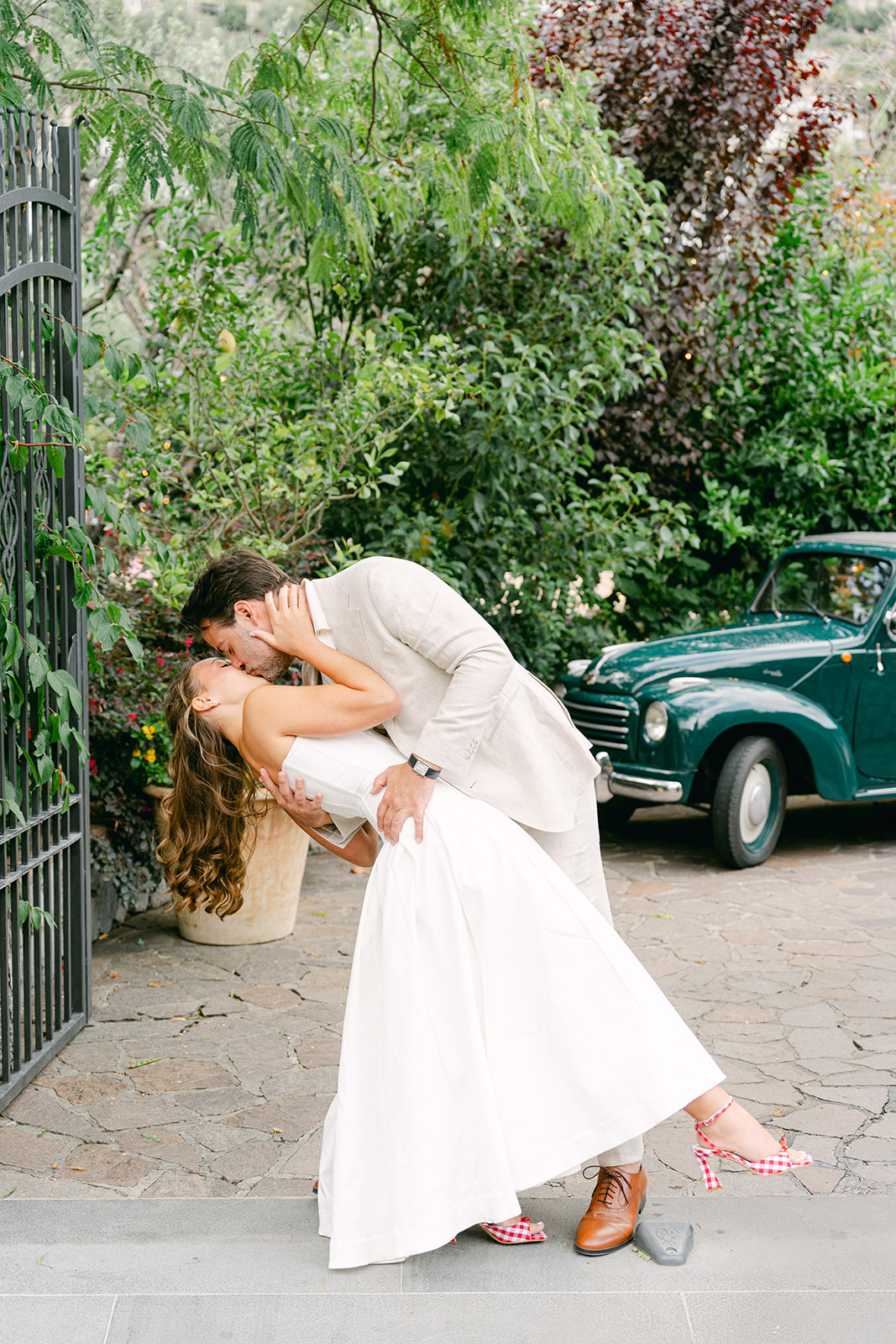 bride and groom kissing for their wedding portraits