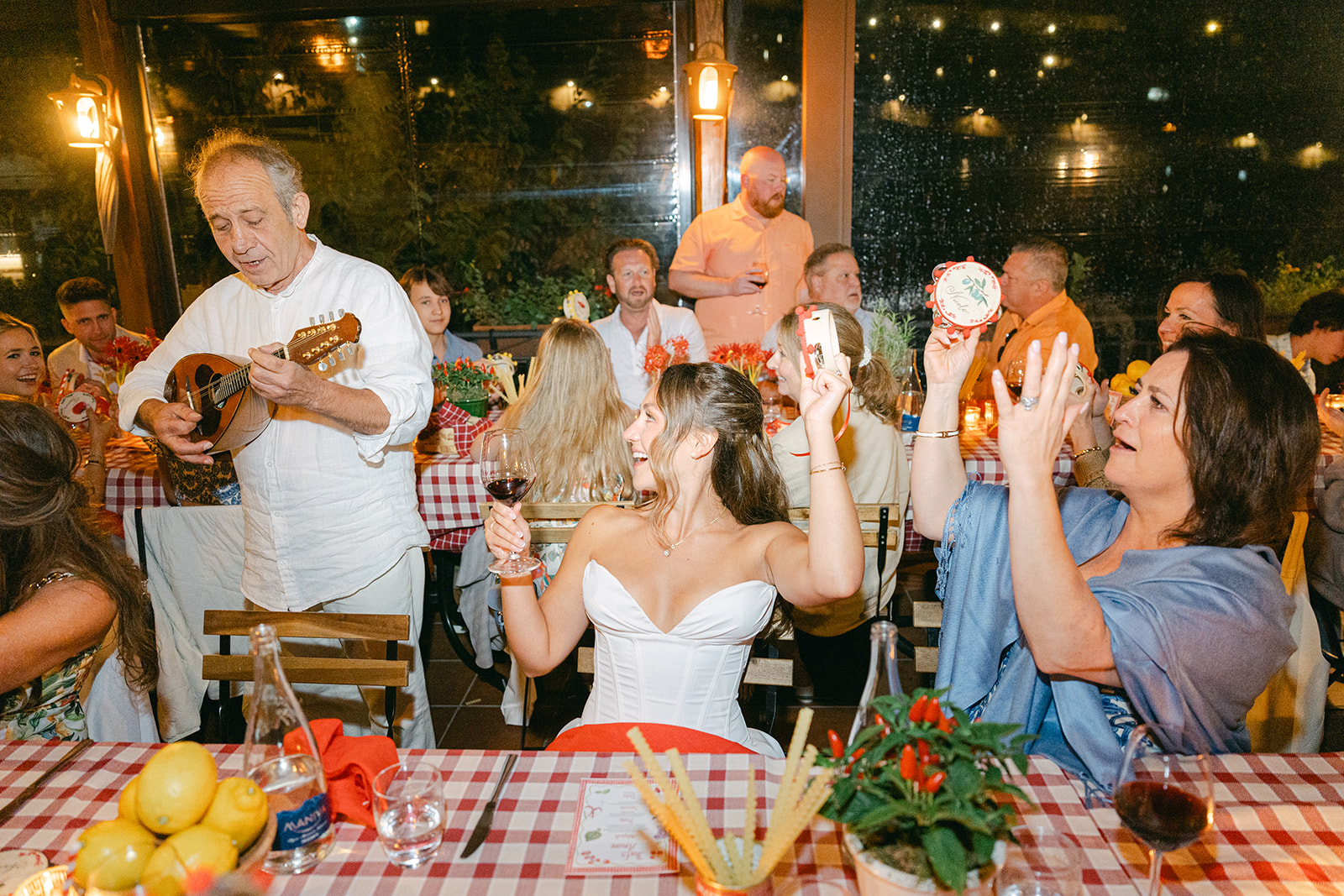 candid wedding photo of the bride and guests vibing to the live music