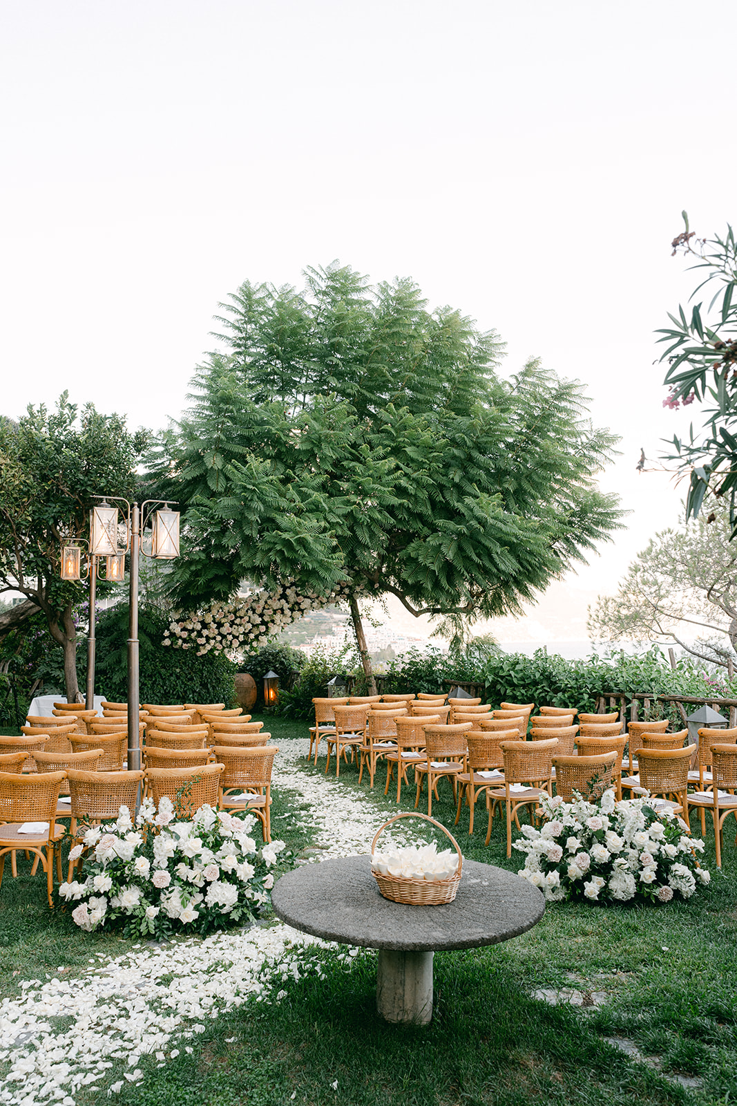 Andrea Gallucci - Destination Wedding Photographer- Amalfi Coast Positano Santorini Barcellona Rome Ravello Paris New York Elegant outdoor ceremony setup with white florals and sea backdrop.