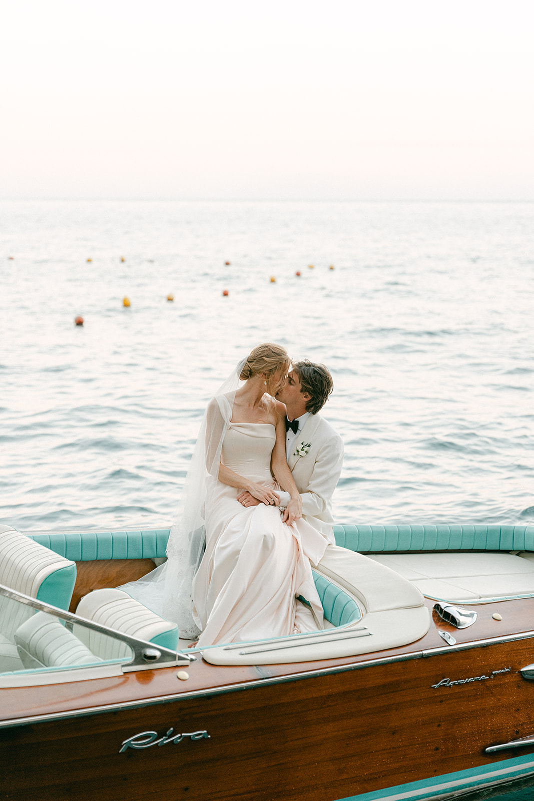 Andrea Gallucci - Destination Wedding Photographer- Amalfi Coast Positano Santorini Barcellona Rome Ravello Paris New York Couple sharing a quiet moment aboard a private yacht following their wedding on the Amalfi Coast, showcasing luxury destination wedding photography in Italy.