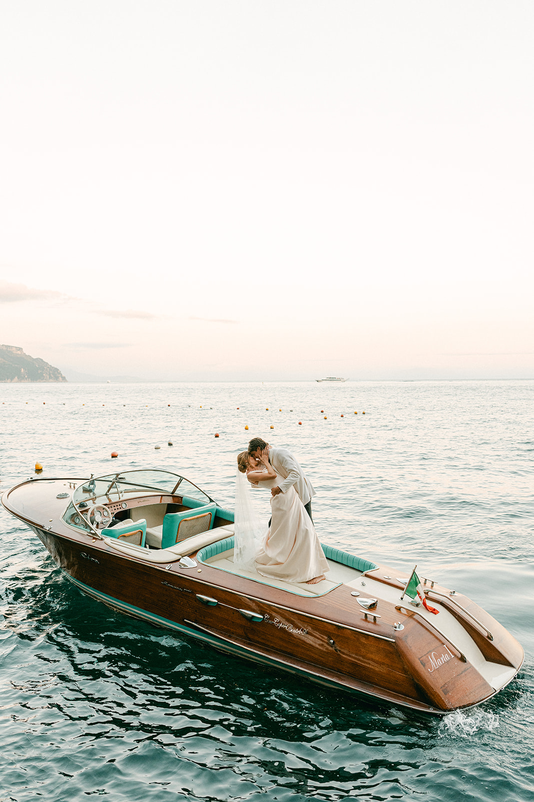 Andrea Gallucci - Destination Wedding Photographer- Amalfi Coast Positano Santorini Barcellona Rome Ravello Paris New York Romantic post-ceremony yacht photos on the Amalfi Coast, bride and groom celebrating with a luxury boat experience and coastal Italian backdrop