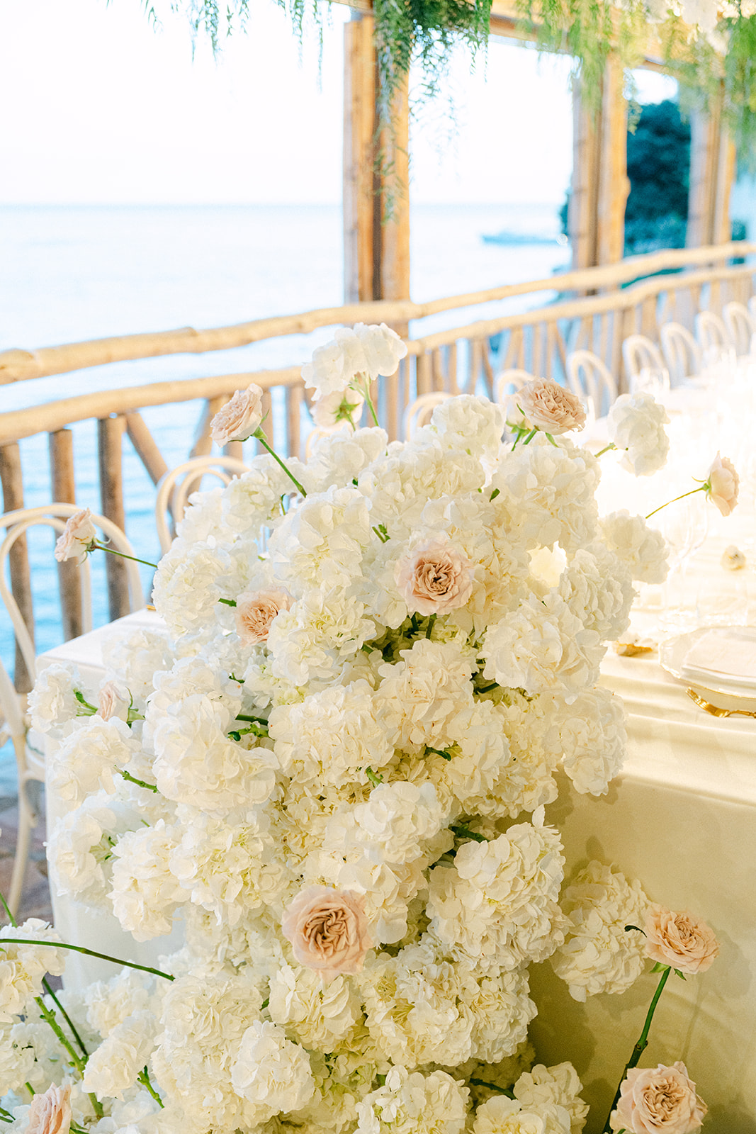 Andrea Gallucci - Destination Wedding Photographer- Amalfi Coast Positano Santorini Barcellona Rome Ravello Paris New York White floral arrangements and draped greenery at Italian wedding