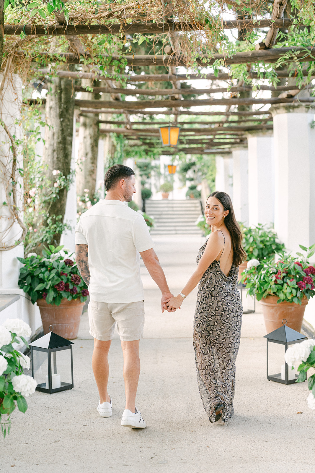 Newly engaged couple walking through Amalfi Coast village