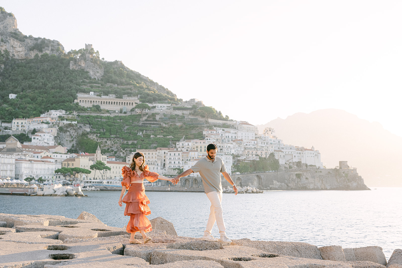 Andrea Gallucci - Destination Wedding Photographer- Amalfi Coast Positano Santorini Barcellona Rome Ravello Paris New York Couple embracing with sea views during an Amalfi Coast vacation photoshoot