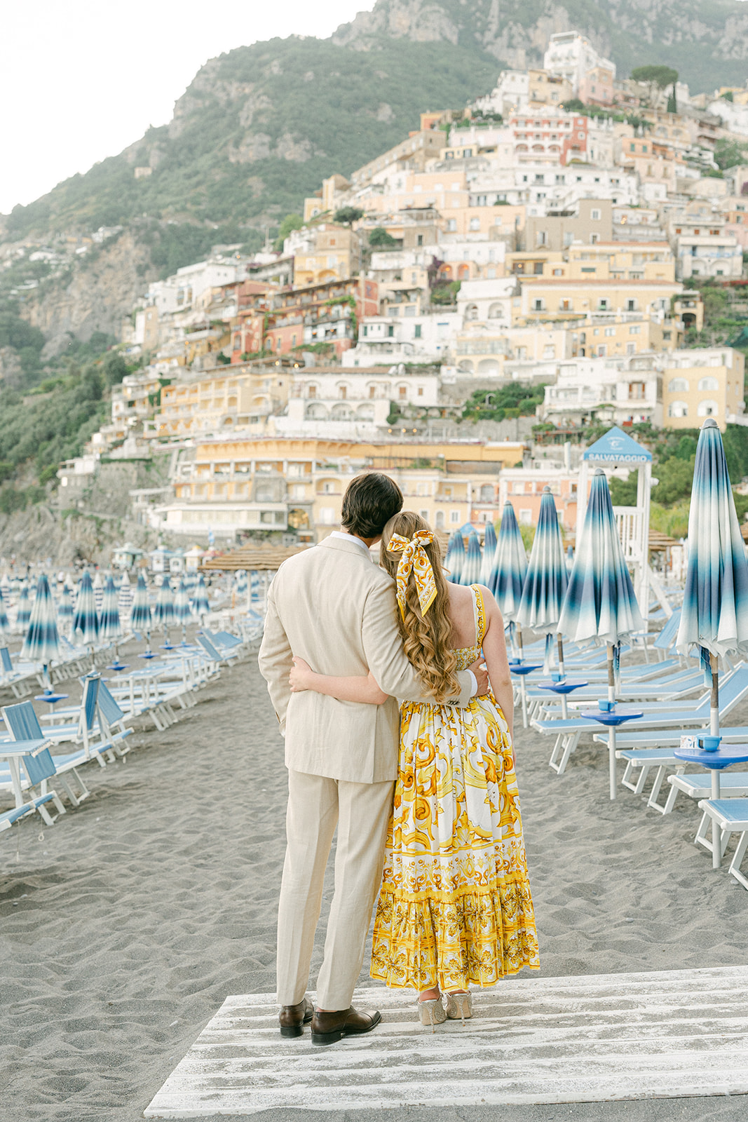Andrea Gallucci - Destination Wedding Photographer- Amalfi Coast Positano Santorini Barcellona Rome Ravello Paris New York Positano beach engagement photoshoot with colorful Amalfi Coast village backdrop