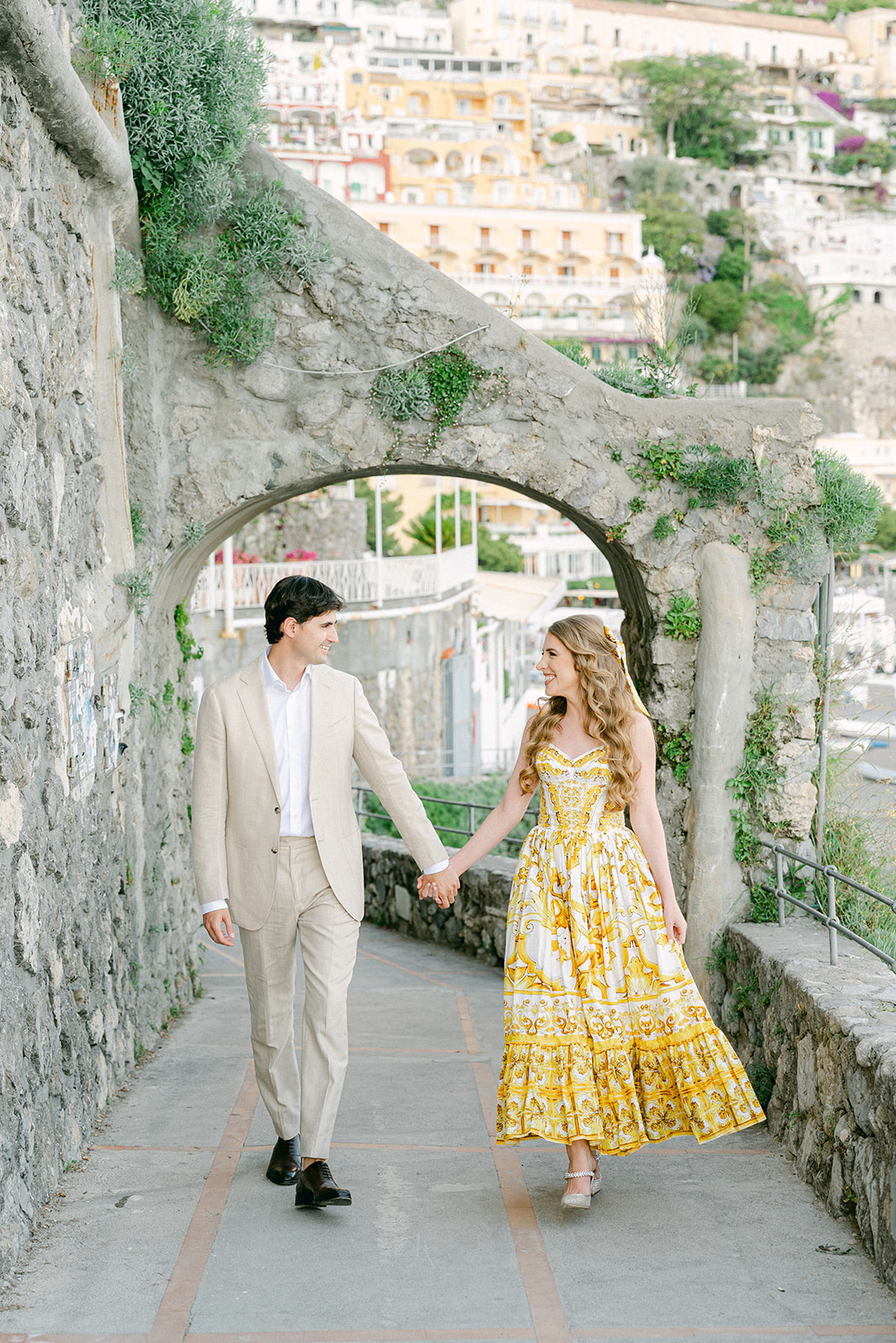 Andrea Gallucci - Destination Wedding Photographer- Amalfi Coast Positano Santorini Barcellona Rome Ravello Paris New York Couple walking through Positano streets during Amalfi Coast vacation engagement photos